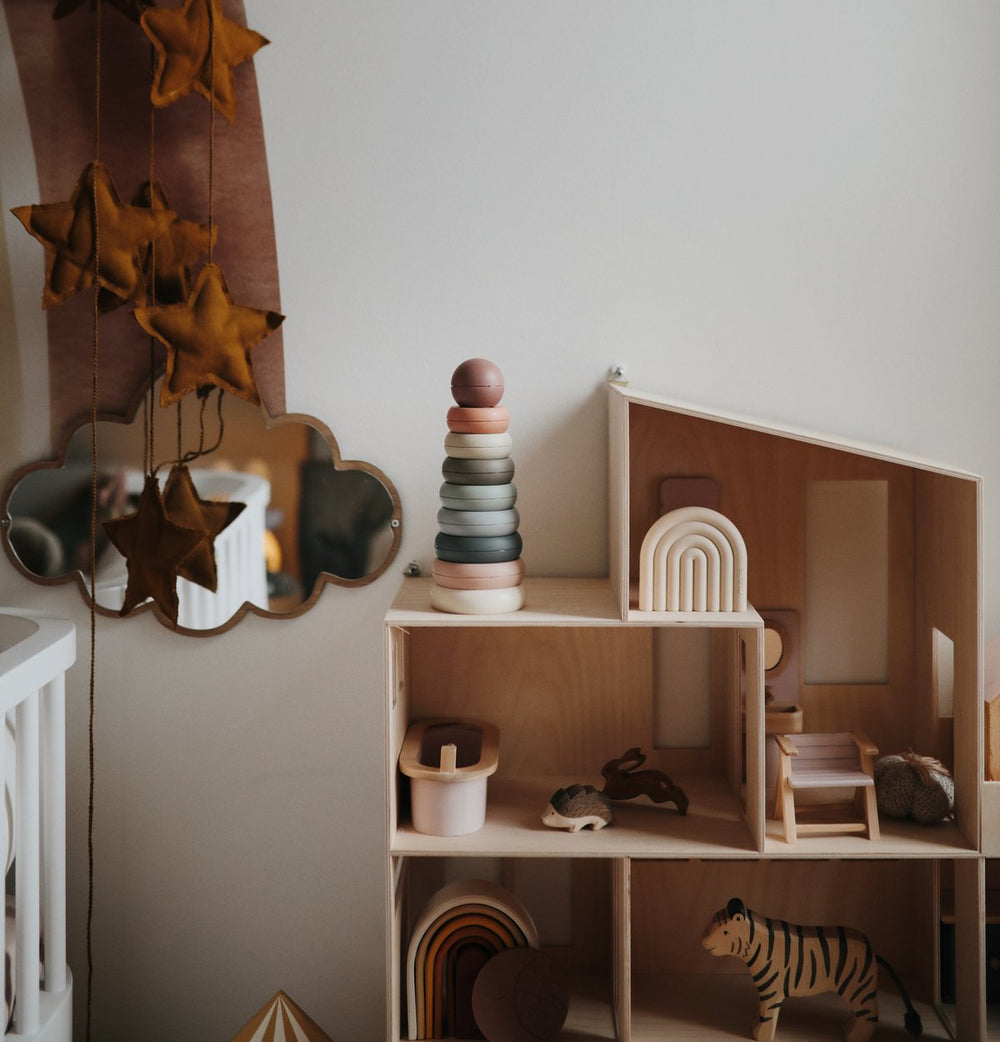 Nursery doll house shelf with Mushie original ring stacking tower toy