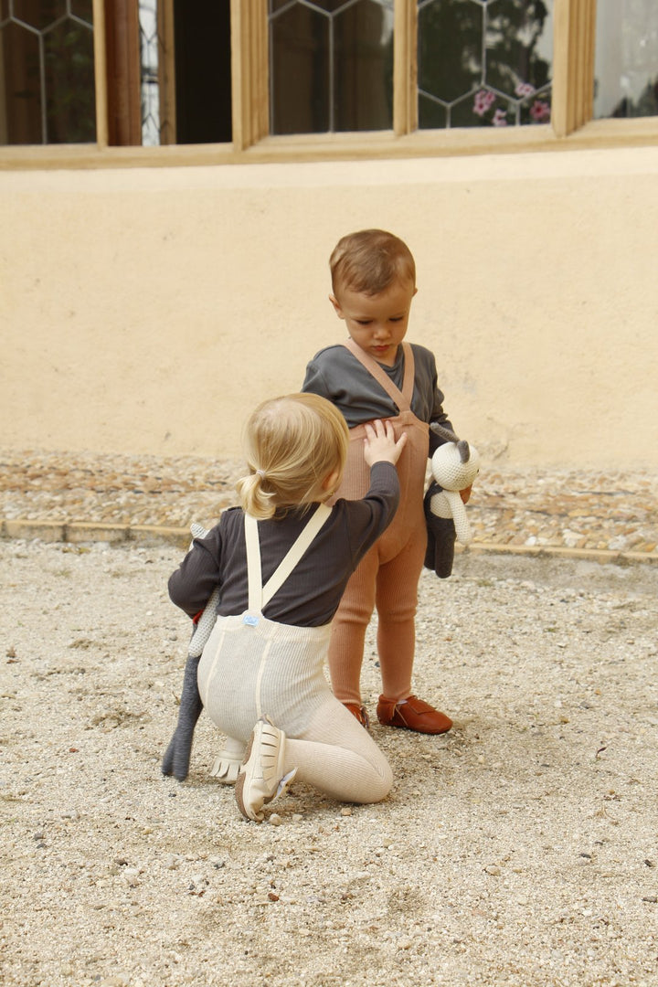 Toddler girl wearing Silly Silas cream beige white cotton ribbed tights with braces/suspenders