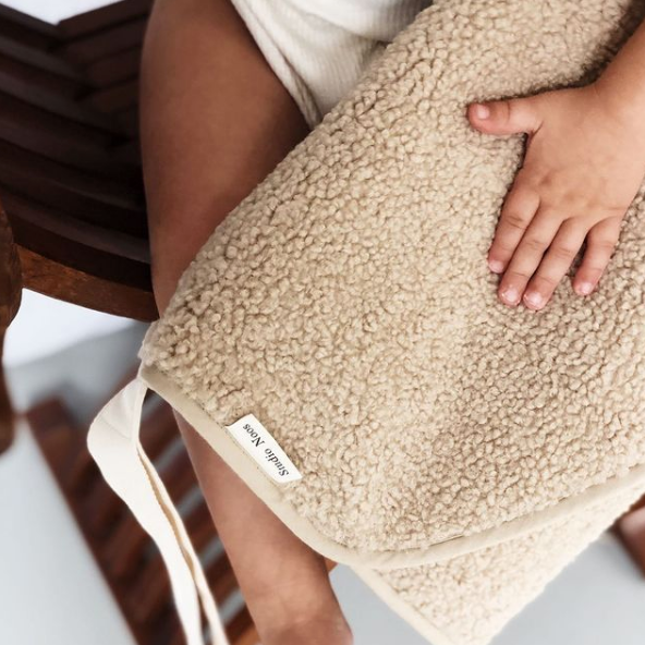 Baby hand holding Beige white cream ecru  chunky teddy change mat portable with strap