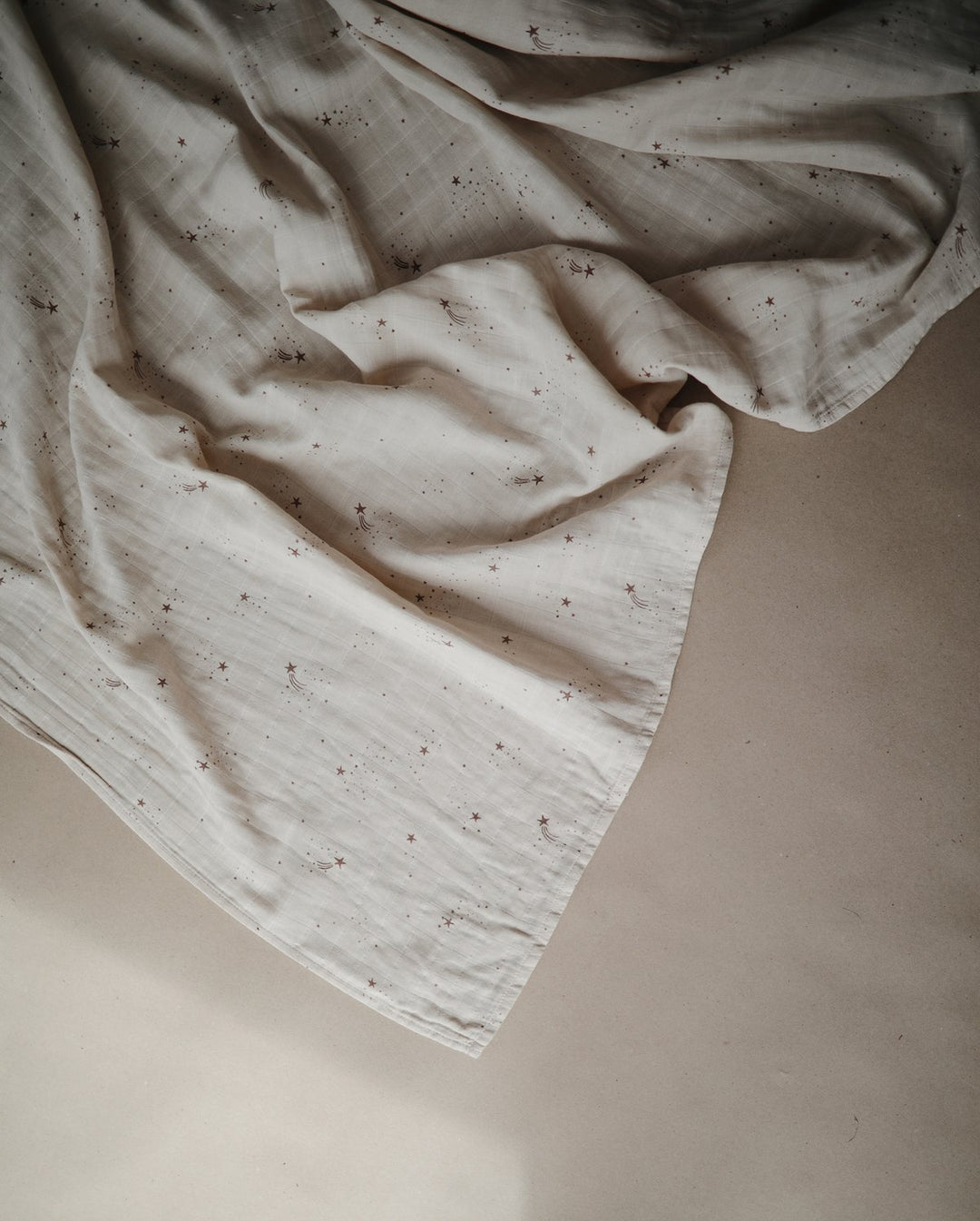 Mushie large muslin organic cotton baby swaddle blanket with falling stars print neutral