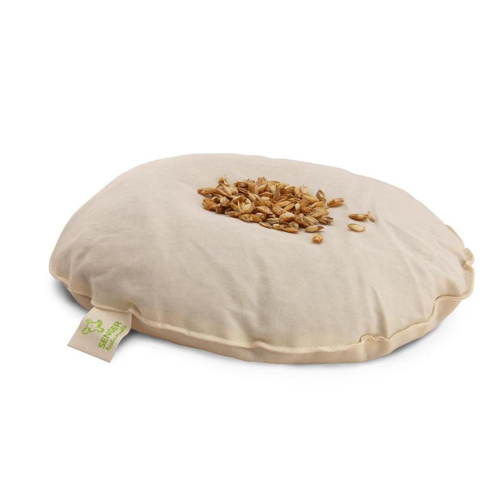 Tan oval pillow with spelt chaff on top 